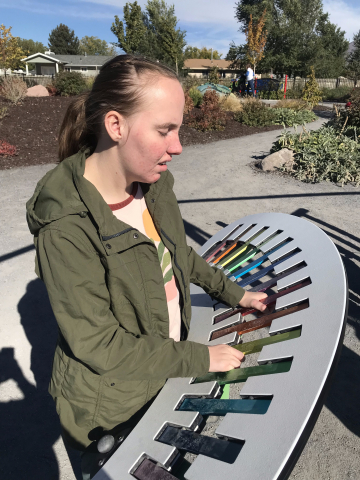 girl standing at xylophone