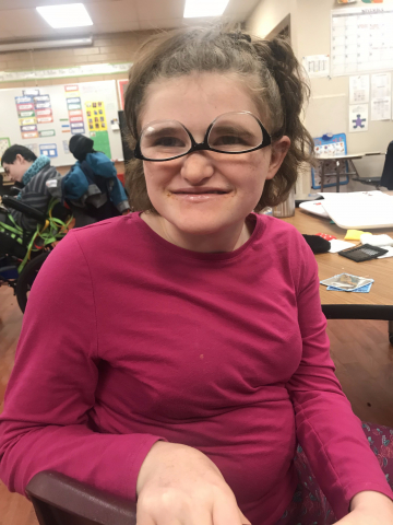 girl smiling with upside down glasses