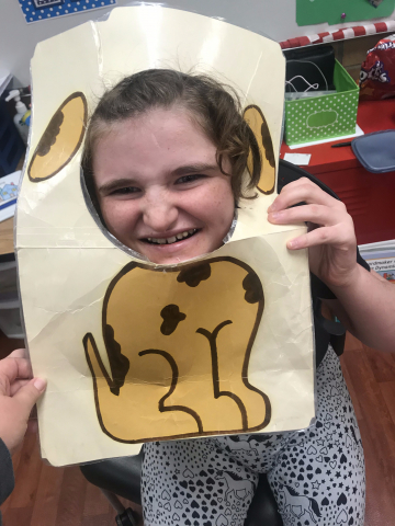 girl holding head in dog cut-out