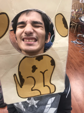 boy holding head in dog cut-out