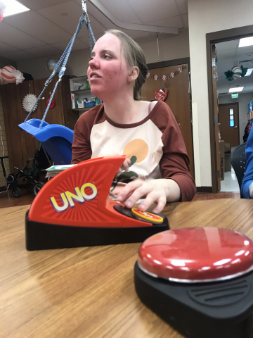student pushing uno button