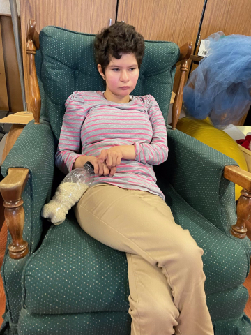 child sitting in rocking chair 