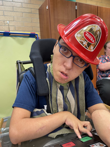 boy wearing firefighter hat
